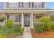 Inviting front porch with stone walkway, lush plants, and decorative window detail at 186 Jupiter Ln, Summerville, SC 29483