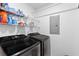 Laundry room featuring a black washer and dryer and white shelving at 186 Jupiter Ln, Summerville, SC 29483