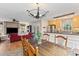 Open-concept layout with a dining area and living room with stone fireplace at 186 Jupiter Ln, Summerville, SC 29483