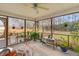 Relaxing screened patio featuring comfortable seating, plants, and a view of the landscaped backyard at 186 Jupiter Ln, Summerville, SC 29483