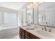Elegant bathroom featuring a double vanity, a separate shower, and a soaking tub at 1901 Hubbell Dr, Mount Pleasant, SC 29466