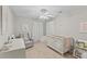 Neutral bedroom showcasing a crib, glider, and desk, creating a versatile and inviting space at 1901 Hubbell Dr, Mount Pleasant, SC 29466