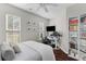 This bedroom features neutral walls, dark floors, a ceiling fan, a large bookcase, and a built-in desk area at 1901 Hubbell Dr, Mount Pleasant, SC 29466