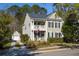 Charming two-story home featuring a double porch, landscaped yard, and detached garage, perfect for Gathering living at 1901 Hubbell Dr, Mount Pleasant, SC 29466