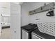 The laundry room features a black washer and dryer set and built-in wire shelving at 1901 Hubbell Dr, Mount Pleasant, SC 29466