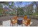 Charming backyard featuring a square fire pit with chairs and a wooden fence, creating a perfect outdoor retreat at 1942 Oak Tree Ln, Mount Pleasant, SC 29464