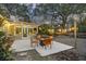 Backyard patio with a fire pit, grill and string lights for evening gatherings at 1942 Oak Tree Ln, Mount Pleasant, SC 29464