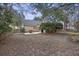 Backyard patio surrounded by a classic wooden fence and mature trees, setting the scene for tranquil outdoor experiences at 1942 Oak Tree Ln, Mount Pleasant, SC 29464
