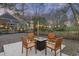 Cozy backyard patio with a fire pit and string lights for outdoor entertaining at 1942 Oak Tree Ln, Mount Pleasant, SC 29464