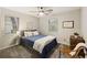 Cozy bedroom features a queen bed, ceiling fan, and natural light from two windows at 1942 Oak Tree Ln, Mount Pleasant, SC 29464