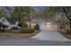 Charming home with a well-maintained front yard, a two car garage, and a welcoming entrance for immediate curb appeal at 1942 Oak Tree Ln, Mount Pleasant, SC 29464