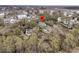 Aerial view of a home with a pool nestled among mature trees, highlighted by a location pin at 215 Fell Pt, Daniel Island, SC 29492