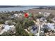 Stunning aerial view of the home surrounded by lush greenery near the bay at 215 Fell Pt, Daniel Island, SC 29492