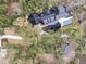 Aerial view showcasing the home's layout, pool, and surrounding wooded landscape at 215 Fell Pt, Daniel Island, SC 29492