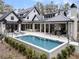 Expansive outdoor living area with a pool, covered patio, and comfortable seating arrangements at 215 Fell Pt, Daniel Island, SC 29492