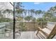 Relax on the balcony with seating and beautiful nature view of trees and landscape at 215 Fell Pt, Daniel Island, SC 29492