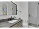 Modern bathroom features a gray vanity, sleek fixtures, and a glass-enclosed shower at 215 Fell Pt, Daniel Island, SC 29492