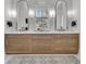 Bathroom featuring double sink vanity with natural wood cabinets and dual arched mirrors at 215 Fell Pt, Daniel Island, SC 29492
