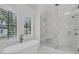 Bright bathroom features a freestanding tub with a large, glass-enclosed shower at 215 Fell Pt, Daniel Island, SC 29492