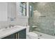 Updated bathroom with green, modern vanity and glass-enclosed shower at 215 Fell Pt, Daniel Island, SC 29492