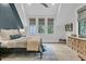 Stylish bedroom with dark accent wall, natural light, and hardwood flooring at 215 Fell Pt, Daniel Island, SC 29492