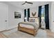 Bedroom with wooden bed frame, ceiling fan, and blue curtains at 215 Fell Pt, Daniel Island, SC 29492