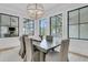 Dining room with a decorative chandelier, large windows, and comfortable seating at 215 Fell Pt, Daniel Island, SC 29492