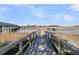 Scenic view from a wooden walkway leading to a private boat dock and harbor, perfect for water enthusiasts at 215 Fell Pt, Daniel Island, SC 29492