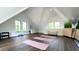 Bright workout room features exercise mats, free weights, and mirrors in converted attic space at 215 Fell Pt, Daniel Island, SC 29492
