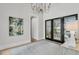 Bright foyer features stylish decor, light wood floors, a modern chandelier, and view to the exterior at 215 Fell Pt, Daniel Island, SC 29492