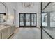 Bright foyer features stylish console table, light wood floors, a modern chandelier, and view to the exterior at 215 Fell Pt, Daniel Island, SC 29492