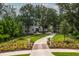Stunning exterior of home with lush landscaping and a long, winding driveway at 215 Fell Pt, Daniel Island, SC 29492