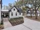 Exterior view of house and walkway showcasing the elegant landscaping and architectural details at 215 Fell Pt, Daniel Island, SC 29492