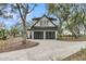 Garage exterior showcasing the black garage doors and concrete driveway surrounded by trees at 215 Fell Pt, Daniel Island, SC 29492