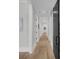 Bright hallway with wood floors and white trim features a decorative sliding barn door at 215 Fell Pt, Daniel Island, SC 29492