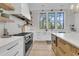 Well-lit kitchen featuring stainless steel appliances, open shelves and a large island perfect for meal preparation at 215 Fell Pt, Daniel Island, SC 29492