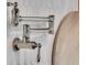 Close-up of a stylish pot filler faucet, adding a touch of elegance and convenience to this chef-inspired kitchen at 215 Fell Pt, Daniel Island, SC 29492