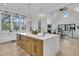 Open-concept kitchen boasts a large island, modern appliances, and seamless flow into the living area with fireplace at 215 Fell Pt, Daniel Island, SC 29492
