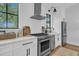 Modern white kitchen with stainless steel appliances, countertops and tiled backsplash at 215 Fell Pt, Daniel Island, SC 29492