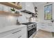 Modern kitchen equipped with stainless steel appliances, including a professional range and open shelving at 215 Fell Pt, Daniel Island, SC 29492