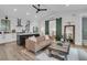 Bright living space features a tan leather couch, kitchen view, and wood barn door at 215 Fell Pt, Daniel Island, SC 29492