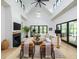 Spacious living room with fireplace, hardwood floors, black trim windows, and vaulted ceilings at 215 Fell Pt, Daniel Island, SC 29492