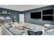 Entertainment room with comfortable seating and an entertainment center on a blue-gray wall at 215 Fell Pt, Daniel Island, SC 29492