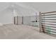 Open loft area with modern railings and light-colored carpeting at 215 Fell Pt, Daniel Island, SC 29492