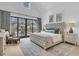 Comfortable main bedroom with access to outdoor pool, accent rug, and ceiling fan at 215 Fell Pt, Daniel Island, SC 29492