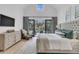 Bright main bedroom with outdoor access, accent rug, ceiling fan, and TV at 215 Fell Pt, Daniel Island, SC 29492