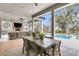 Inviting patio with a large dining table, outdoor fireplace, and a stunning view of the pool at 215 Fell Pt, Daniel Island, SC 29492