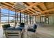 Bright patio with wooden ceiling, ample seating, and stunning water views through large glass windows at 215 Fell Pt, Daniel Island, SC 29492