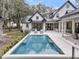Stunning backyard pool with lounge chairs and expansive views of the modern home at 215 Fell Pt, Daniel Island, SC 29492