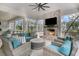 Covered porch featuring an outdoor fireplace and comfortable seating for relaxing and entertaining at 215 Fell Pt, Daniel Island, SC 29492